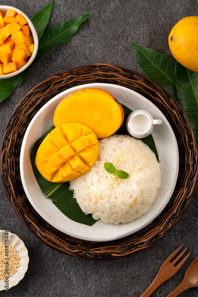 Delicious Thai mango sticky rice with cut fresh mango fruit in a plate.