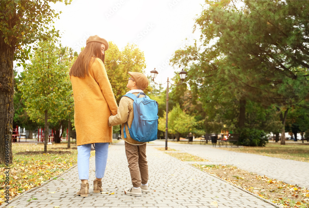 Woman walking her little son to school