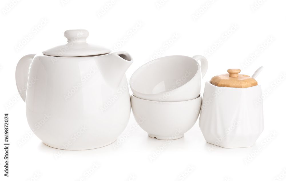 Ceramic teapot with cups and sugar bowl on white background