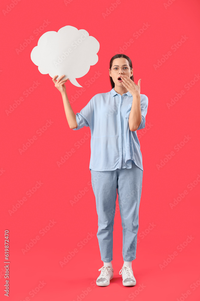 Shocked young woman with blank speech bubble on red background