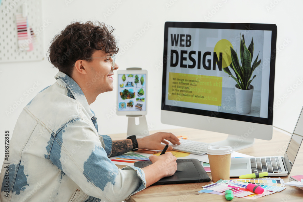 Male graphic designer working at table in office