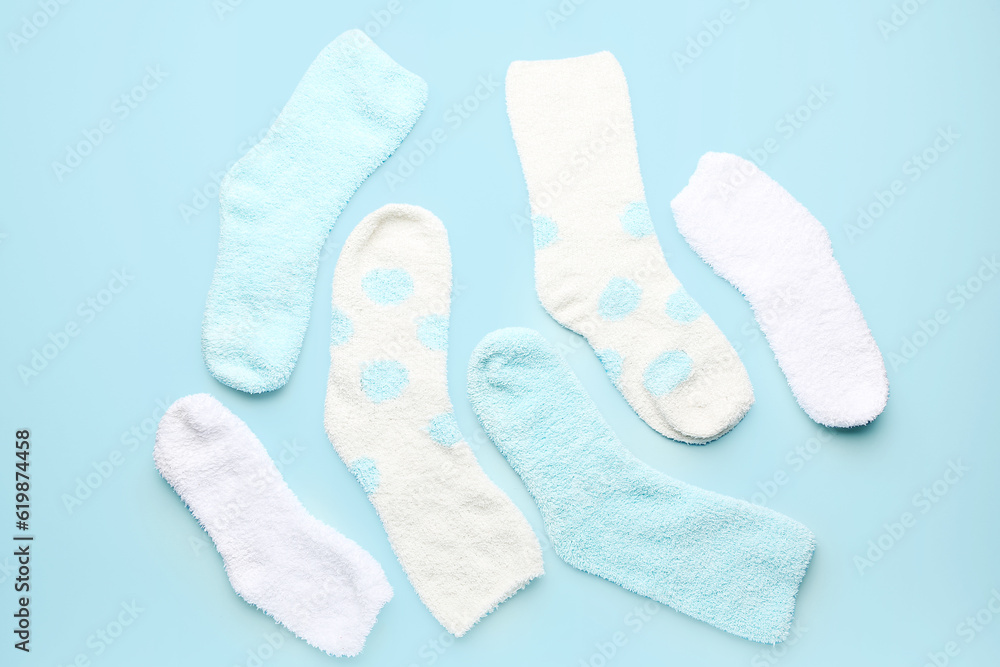 Set of warm socks on color background