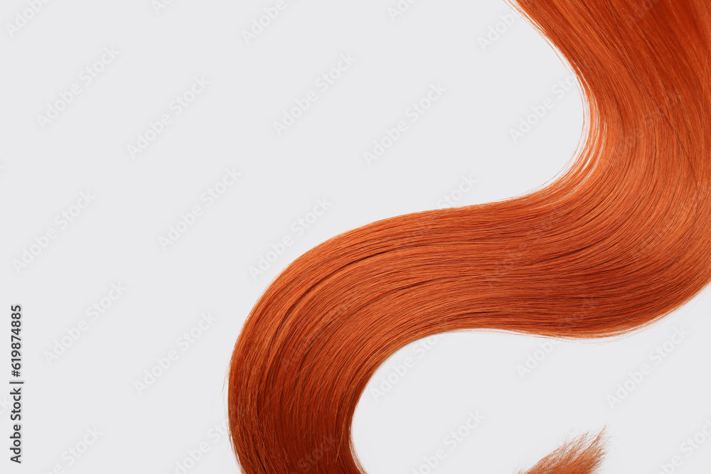 Beautiful ginger hair strand isolated on white background, closeup