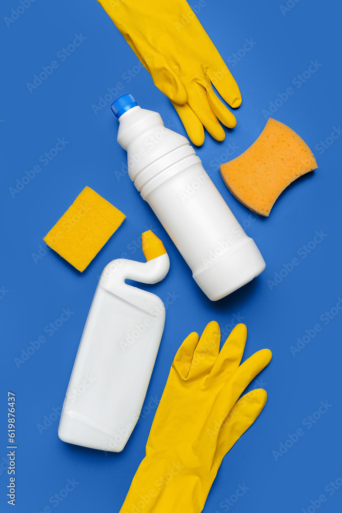 Different cleaning supplies on blue background