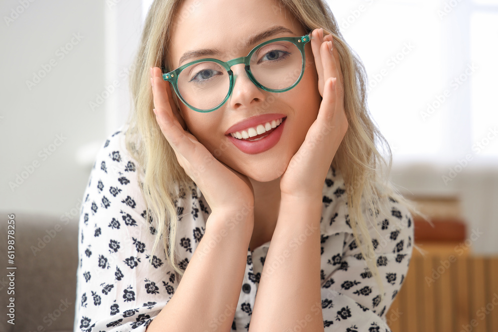 Young woman in stylish eyeglasses at home