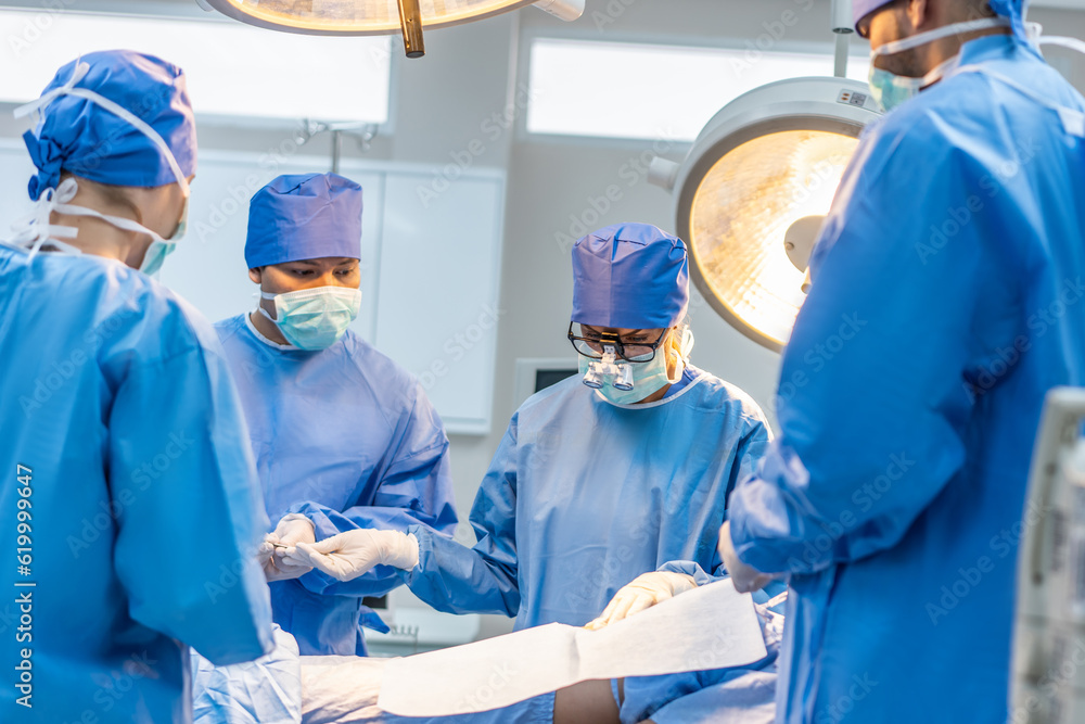 Professional doctors performing surgical operation in operating room. 