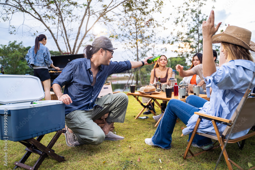 Group of diverse friend having outdoors camping party together in tent. 