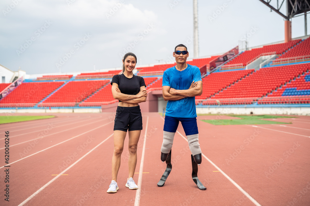 Portrait of Asian para-athlete disabled and trainer standing in stadium. 