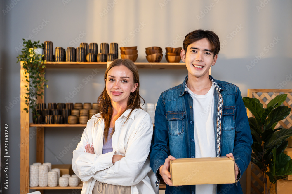 Portrait young man and woman check vase order on shelf for customer. 