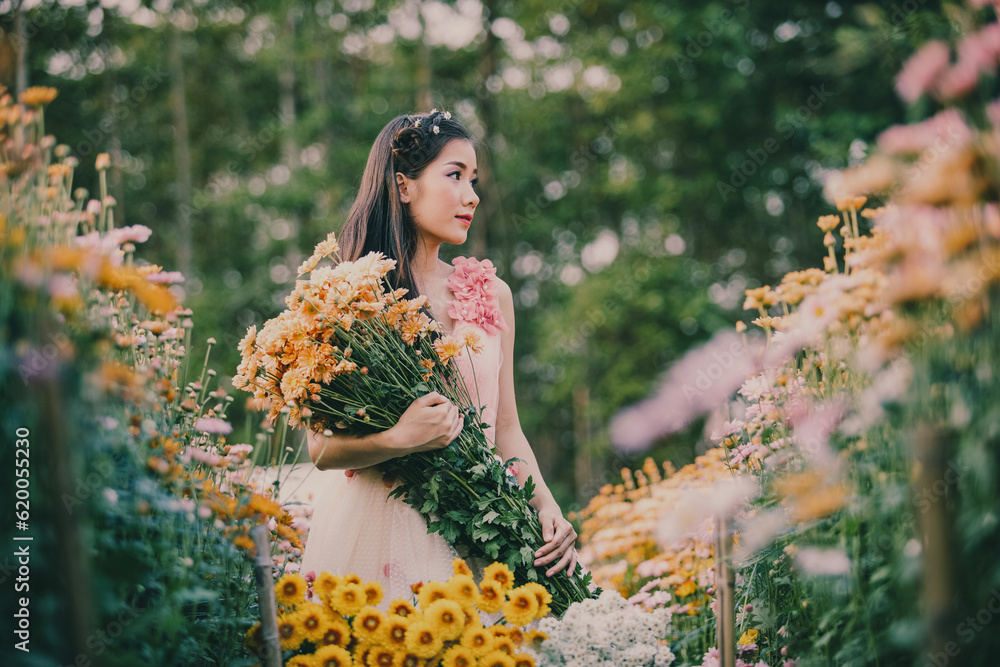 Portrait of beautiful girl in field,Beautiful girls are happy with colorful flowers,colorful bouquet