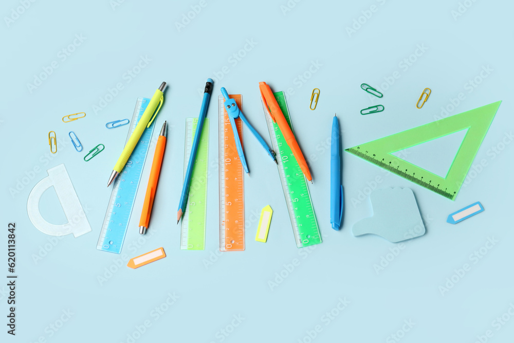 Composition with stationery supplies on blue background