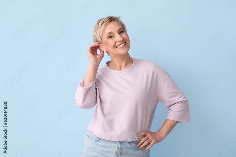 Mature blonde woman on blue background