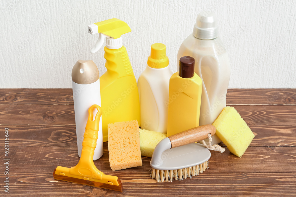 Set of cleaning supplies on wooden table