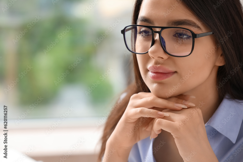 Beautiful young woman wearing glasses in office