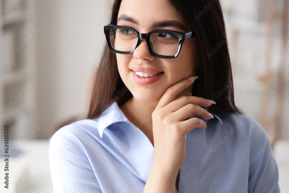 Beautiful young woman wearing glasses in office