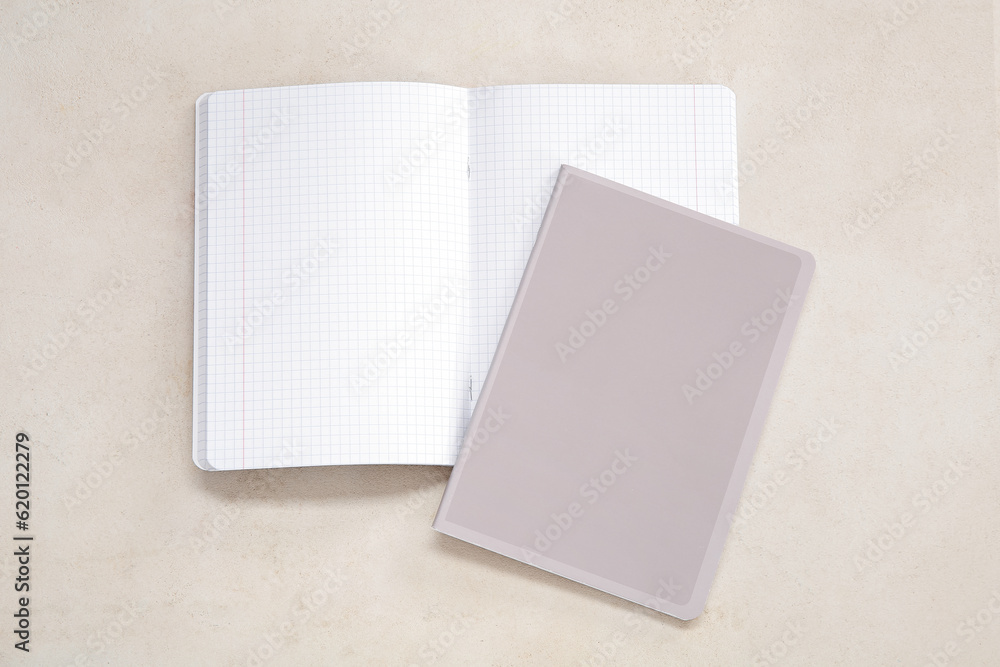 Different notebooks on beige background