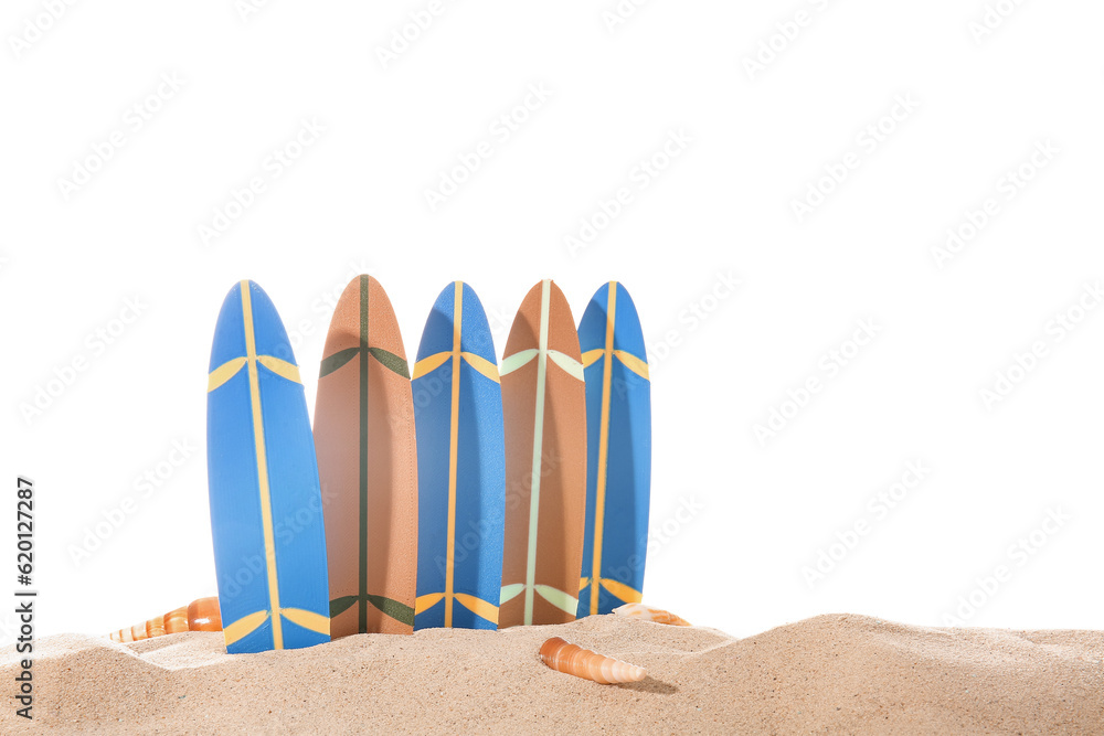 Mini surfboards with seashells on sand against white background