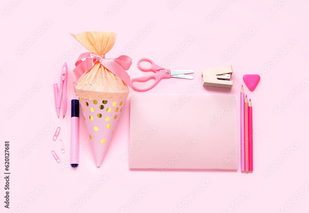 School cone with different stationery on pink background