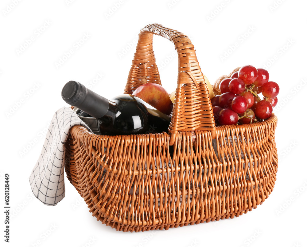 Wicker basket with tasty food for picnic and wine on white background