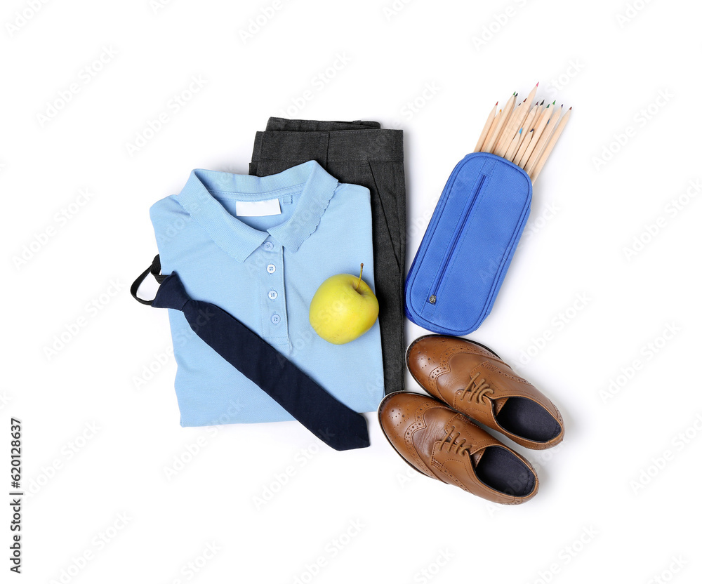 Stylish school uniform with fresh apple and stationery isolated on white background