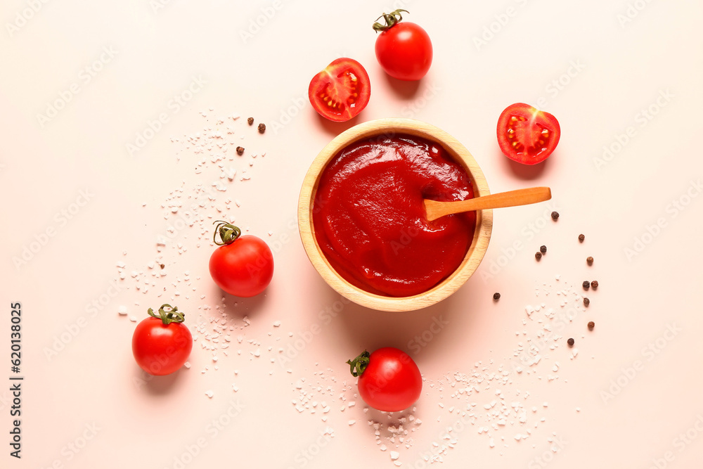 Bowl with tomato paste and fresh vegetables on light background