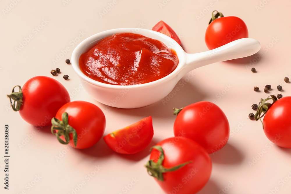 Bowl with tomato paste and fresh vegetables on light background