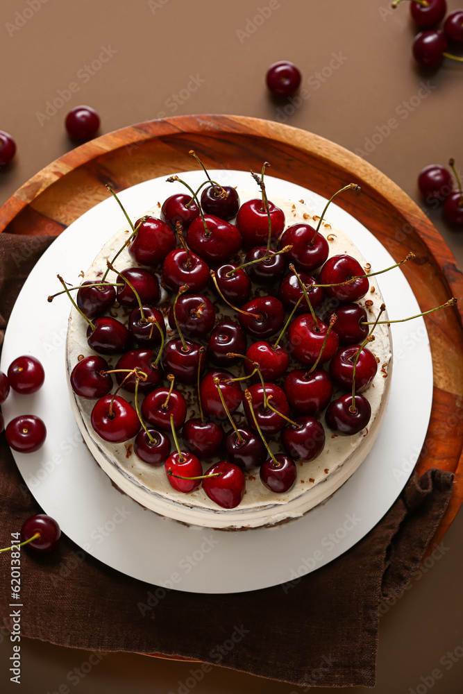 Wooden stand with tasty cherry cake on red background