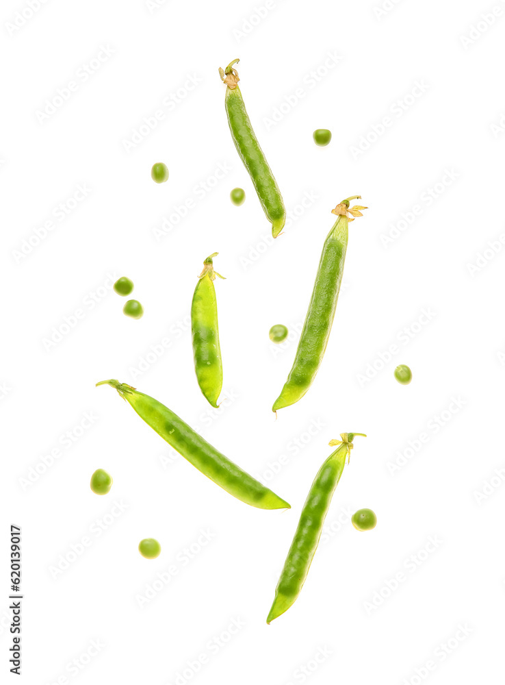 Flying green pea pods on white background