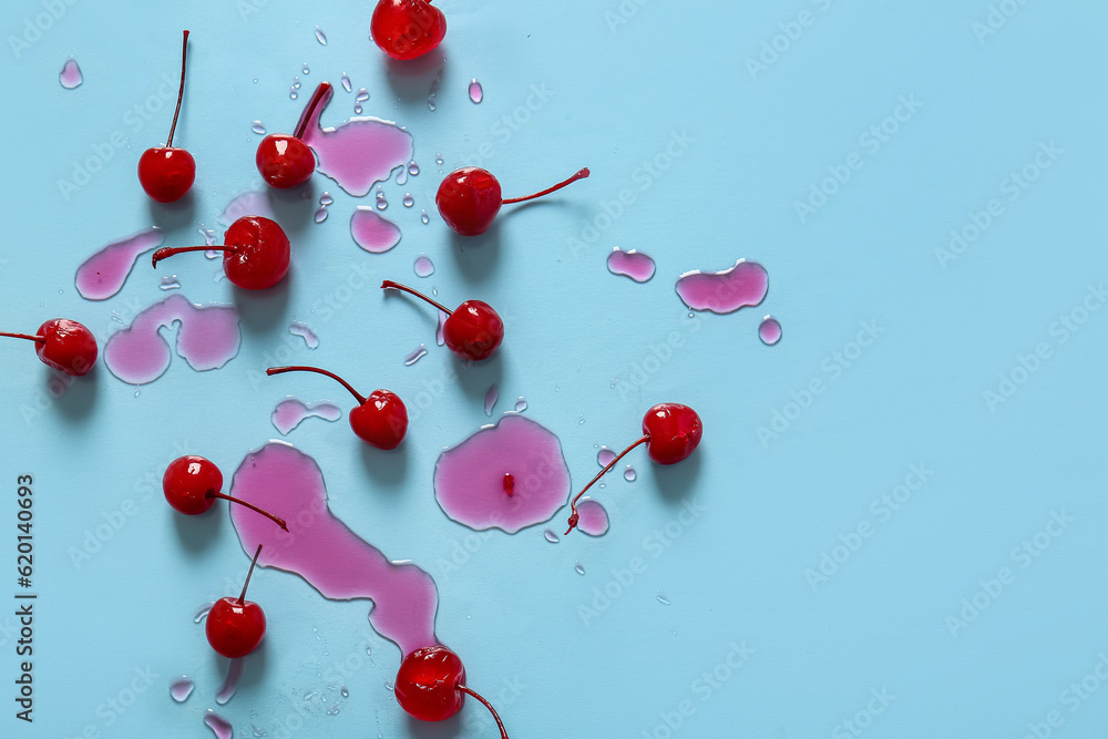 Tasty maraschino cherries on blue background