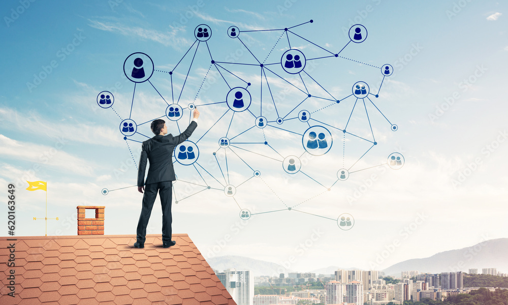 Businessman on house roof presenting networking and connection c