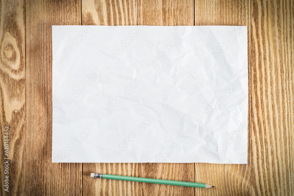 Sheet of paper lying on wooden table