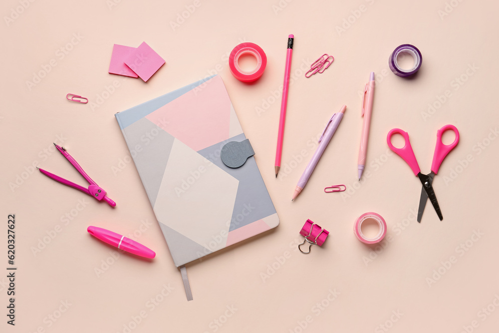 Composition with notebook and stationery supplies on pink background