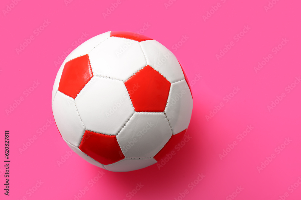 Soccer ball on pink background