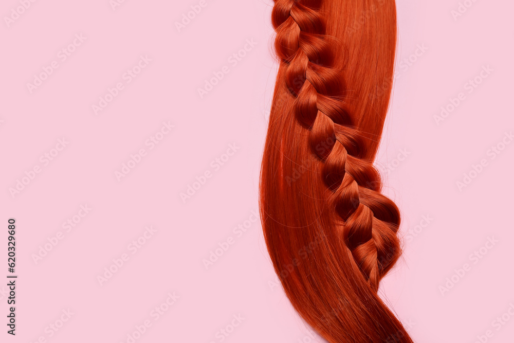 Ginger hair and braid on color background, closeup