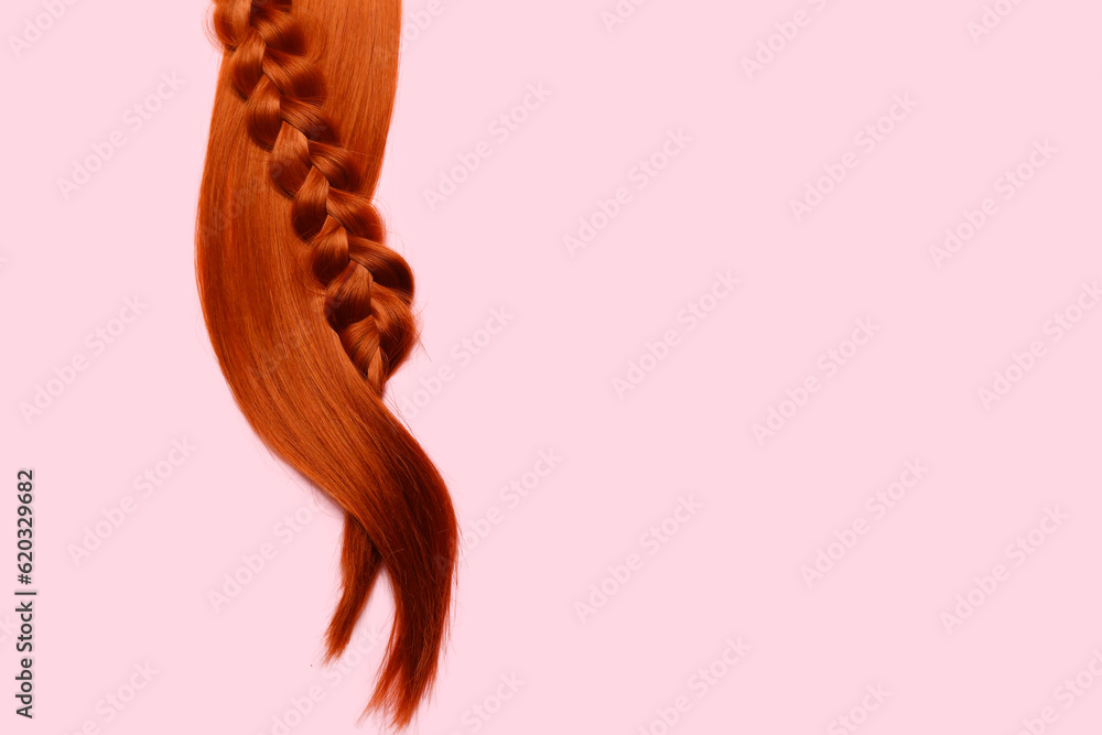 Ginger hair and braid on color background, closeup