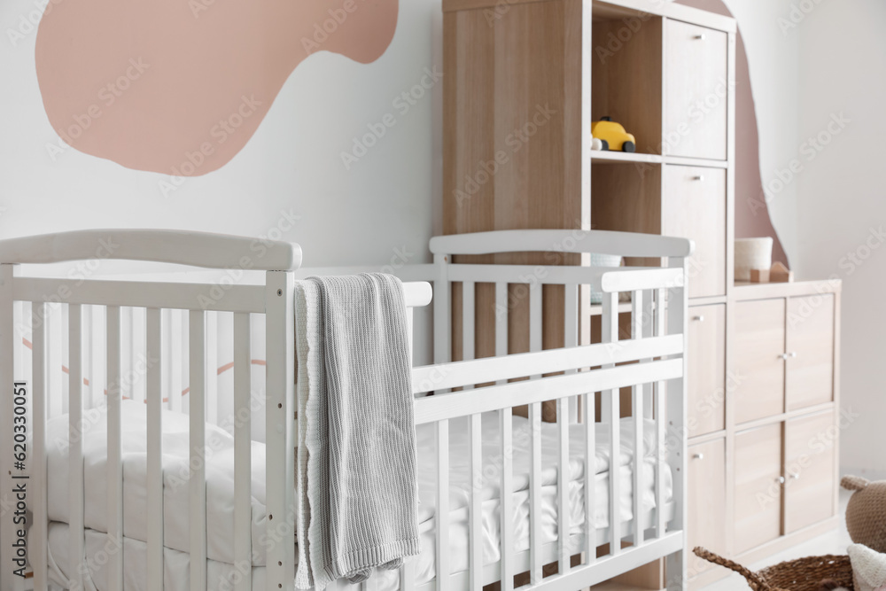 Interior of childrens bedroom with bed and shelving unit