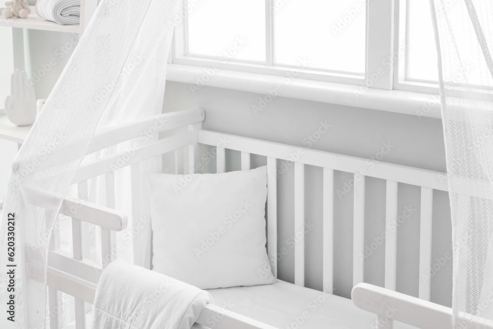 Interior of stylish childrens bedroom with crib