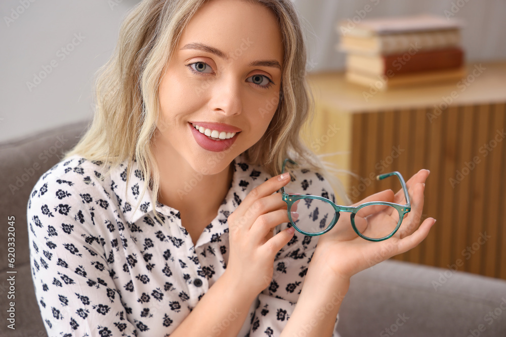 Young woman with stylish eyeglasses at home, closeup