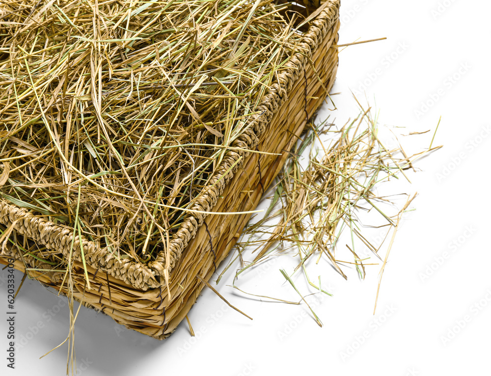 Straw in basket on white background