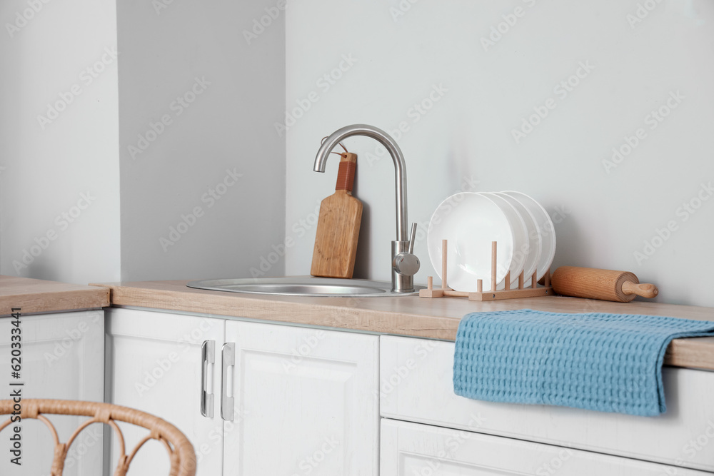 Sink and plate rack on wooden countertop in modern kitchen