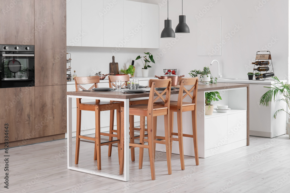 Interior of modern kitchen with served island table