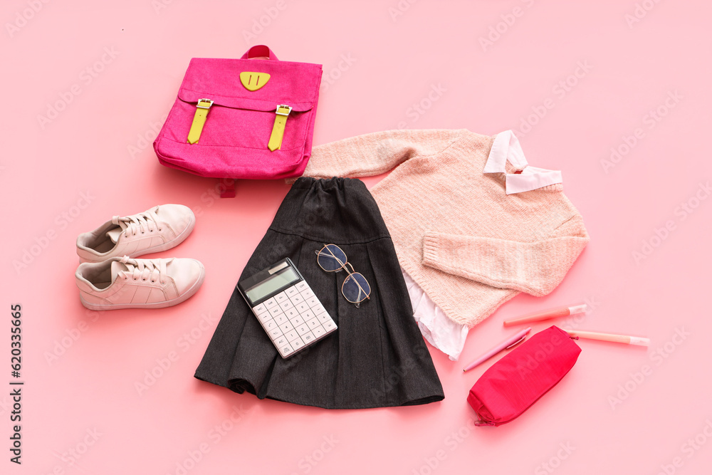 Composition with stylish school uniform, backpack, eyeglasses and stationery on pink background