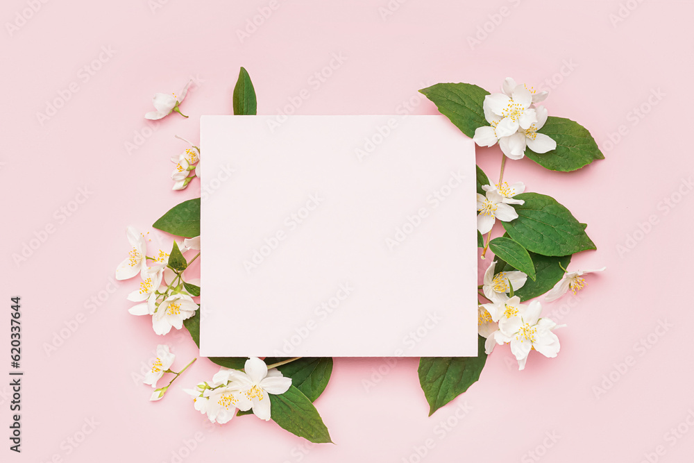 Composition with blank card and beautiful jasmine flowers on pink background