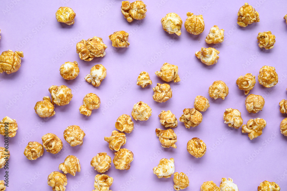 Tasty popcorn on purple background