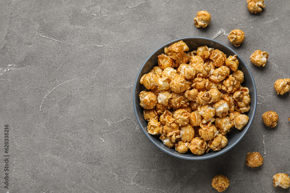 Bucket with tasty popcorn on grey background