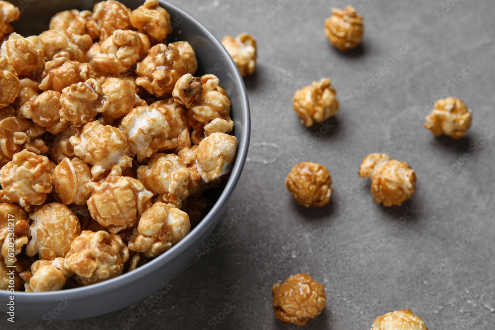 Bucket with tasty popcorn on grey background