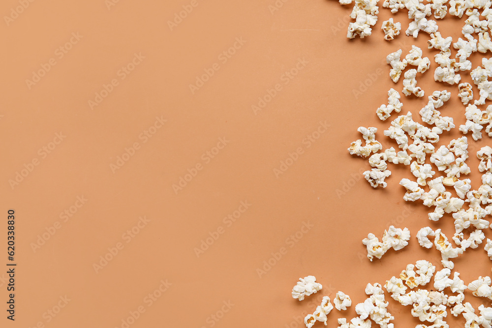 Tasty popcorn on brown background