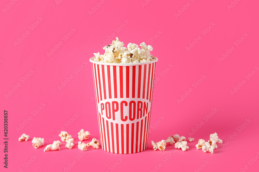 Bucket with tasty popcorn on pink background