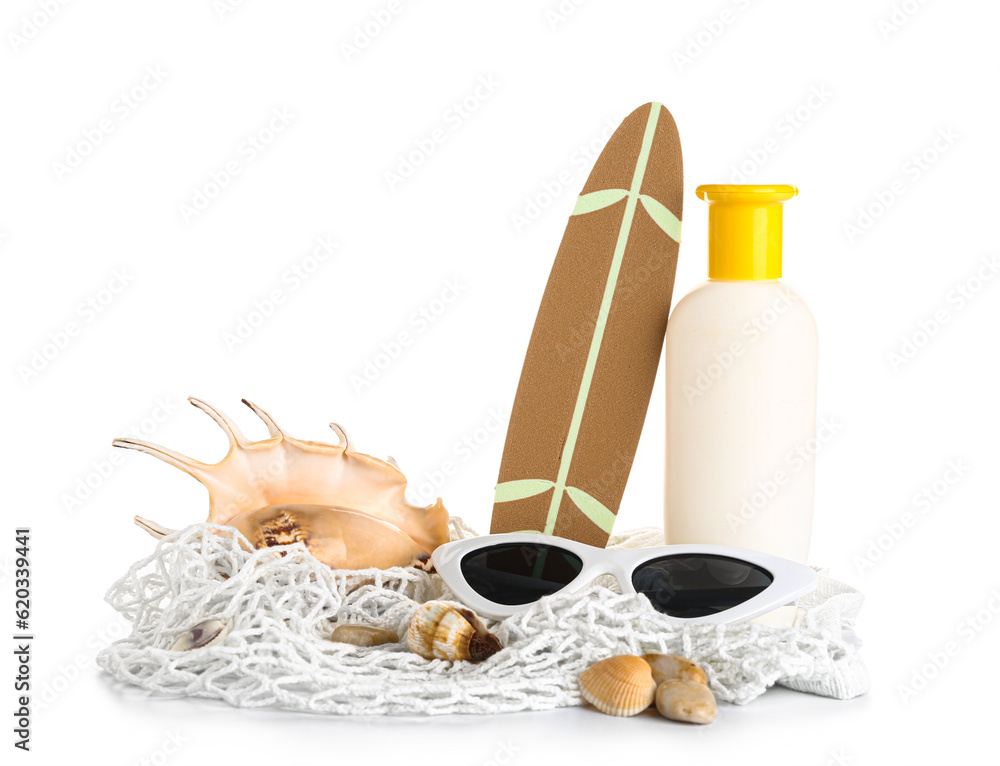 String bag with mini surfboard, sunglasses and bottle of sunscreen cream isolated on white backgroun