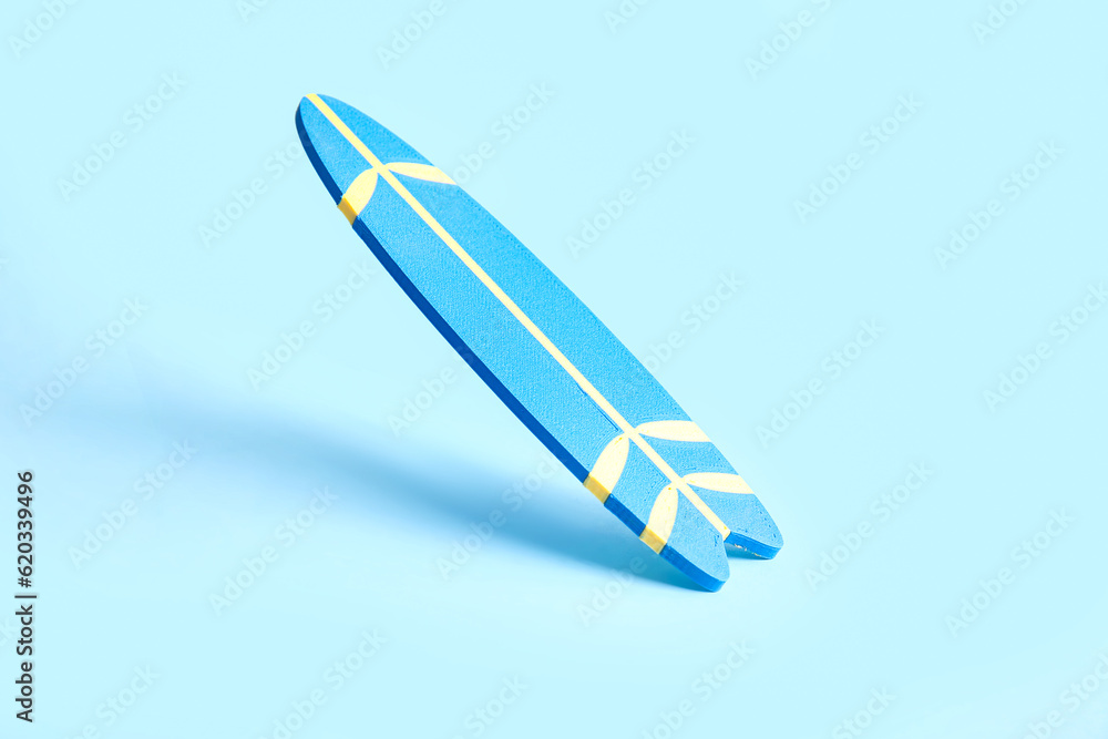 Mini color surfboard on blue background